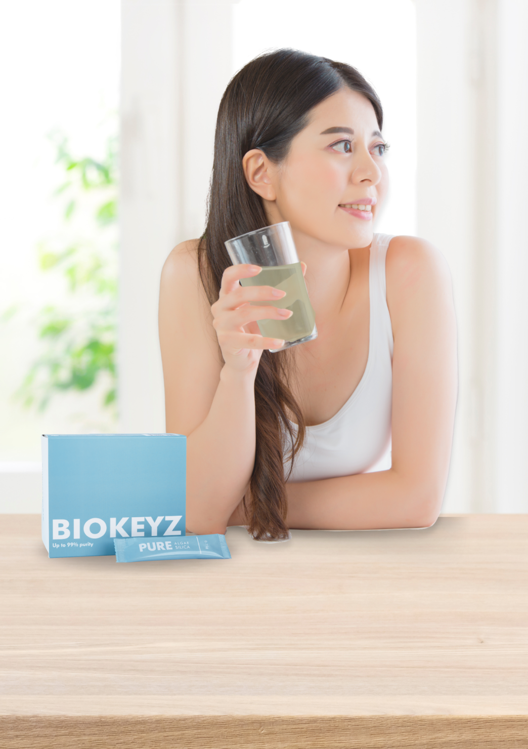 A girl holding a sachet of Pure Biokeyz